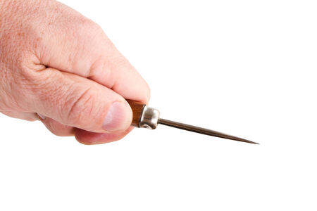 hand with a sharp pricker on a white backgroundの写真素材