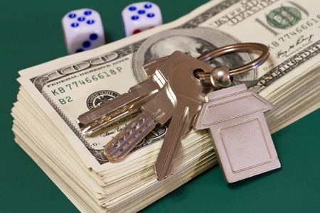  keys money and rolling dice on a green table, selective focusの写真素材