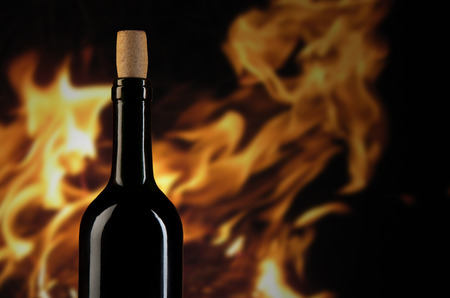 Wine bottle on dark fireplace backgroundの写真素材