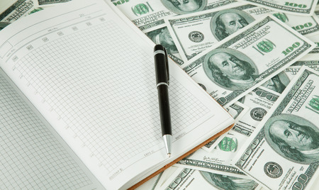 Background with money american hundred dollar and pen and noteの写真素材
