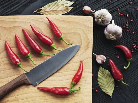 Knife chef  red chili pepper and spice on  wooden background