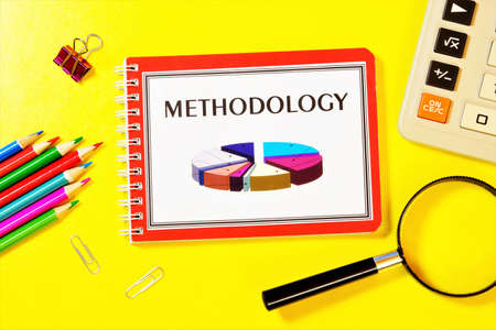 Methodology-writing the text in the research notebook. Teaching about strategies for studying the subject.の写真素材