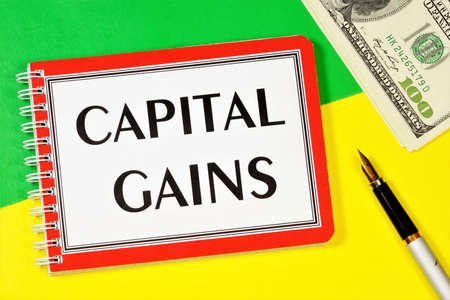 Capital gains-text label on the planning strategy Notepad. Money to Finance a business.の写真素材