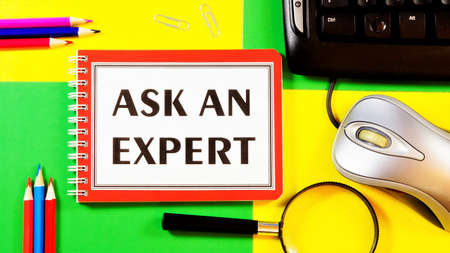 Ask an expert's opinion-text inscription on a Notepad. Evaluation for the purpose of making a responsible decision or choice. Getting an answer to a question.の写真素材