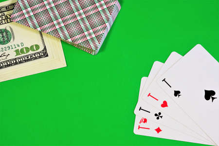 Aces, a deck of cards and money on the green background of the game table. Card strategy games with an element of chance, there is an element of luck.の写真素材