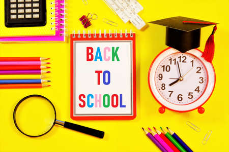 Back to school-text inscription in letters of the alphabet in the student's notebook on the background of stationery. The opportunity to find new knowledge and get an education in the future.の写真素材