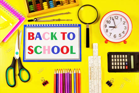 Back to school-text inscription in letters of the alphabet in the student's notebook on the background of stationery. opportunity to learn new knowledge and get an education.の写真素材