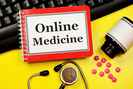 Online medicine-text inscription on a Notepad. News information, consultation, appointment with a specialist doctor.の写真素材