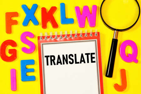 Translate. text inscription on the training notebook. Magnifying glass. The letters of the Latin...
