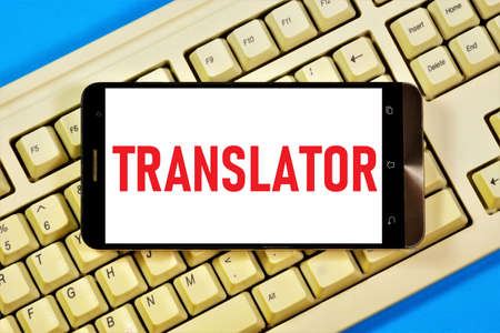 Translator. text inscription in the smartphone on the keyboard. Interpret the meaning of the text in the source language and create a new text in a different language.の写真素材