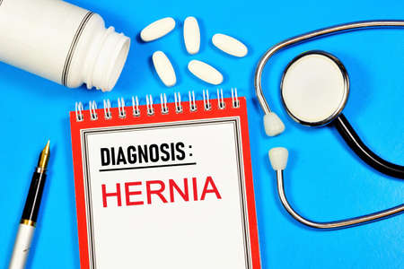A hernia is a text label on a form in a medical folder. The diagnosis was made by a doctor. Prevention and treatment with medications.の写真素材