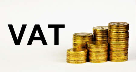 VAT. Text inscription on the background of money coins. Fee in cash. Bill payment.の写真素材