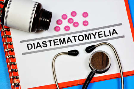 Diastematomyelia is a malformation of the spine and spinal cord. Text inscription on the form in the medical folder. The diagnosis was made by a doctor. Prevention and treatment with medications.の写真素材