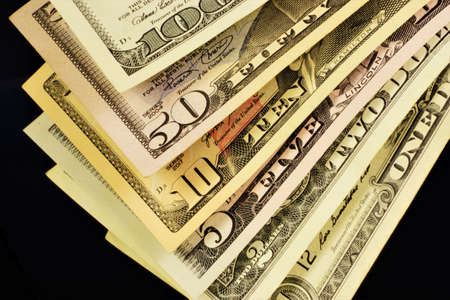 Dollar bills of different denominations. American money, a means of paying for goods and services....