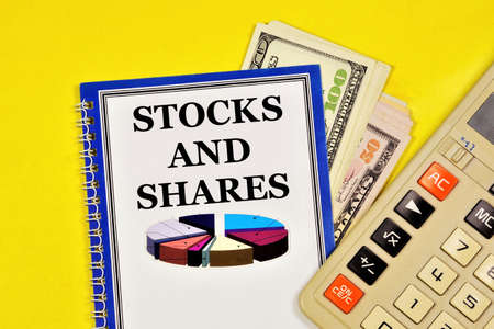 Shares and shares. Text label on the research form. Equity securities that give the owner the right to participate in the management of a joint-stock company and receive part of the profit in the form of dividends.の写真素材