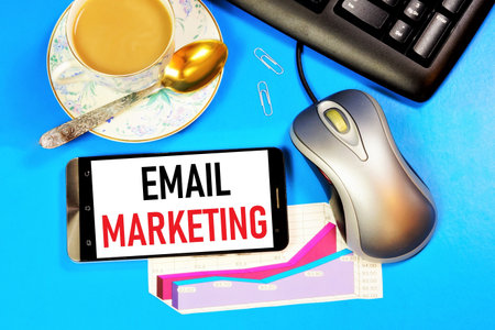 Email marketing. Text label on the screen of the smartphone. The advertising scheme is distributed on the Internet on sites that provide goods and services.の写真素材