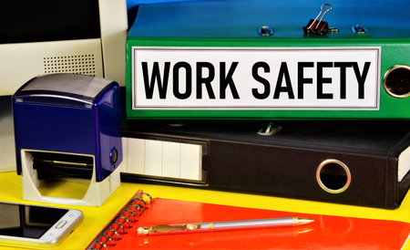 Work safety. Text label on the folder. Monitoring the state of working conditions to reduce injuries and accidents, occupational diseases, and improve working conditions.の写真素材