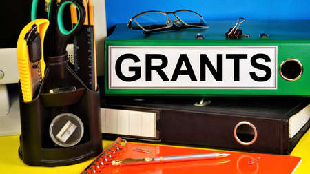 Grants. Text label in the folder. Gratuitous subsidy to organizations and individuals for conducting scientific research.の写真素材