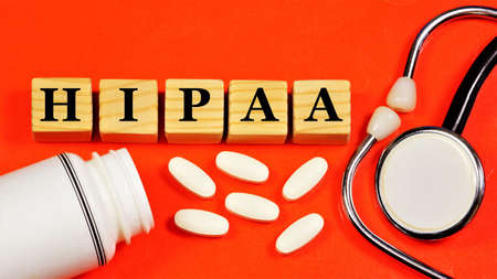 HIPAA. The Health Insurance Accountability Act. A text label in the planning folder against the background of medicines and a phonendoscope.の写真素材