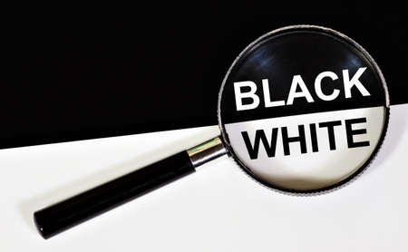 Black and white. An inscription in the magnifying glass of research or selection. Opposite colors.の写真素材