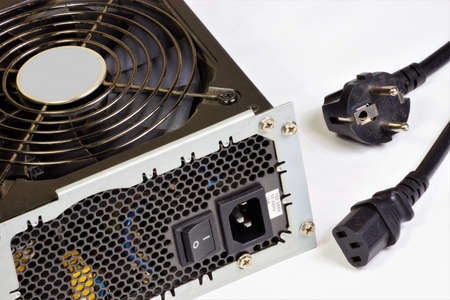 The computer's power supply and network cable. For supplying the computer nodes with DC electricity, converting the mains voltage to the required values.の写真素材