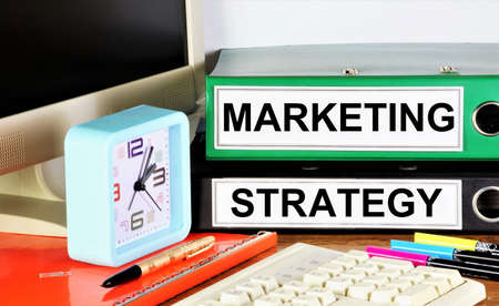 Marketing strategy. The inscription in the business planning folders. Achieving a competitive advantage, searching for new opportunities.の写真素材