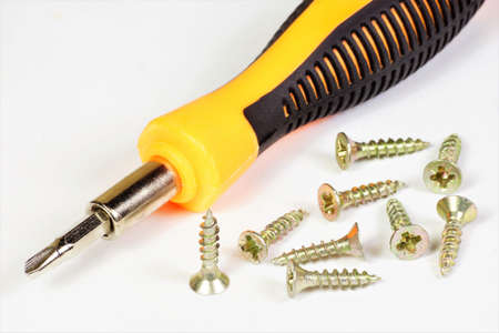 A screwdriver is a locksmith tool for tightening fixing screws. Applicable in construction.の写真素材