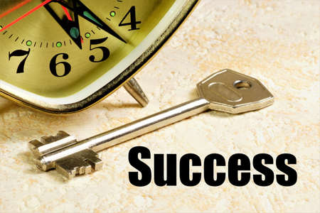 success. The inscription on the background of the clock and the key. The path and achievement of the...