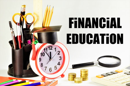 financial education. An inscription on the background of cash coins, a calculator and hours of planning the Study of Knowledge for the successful conduct of business.の写真素材