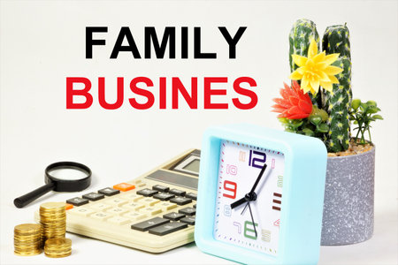 family business. The inscription on the background of the calculator, coins and hours of planning. A type of commercial activity.の写真素材