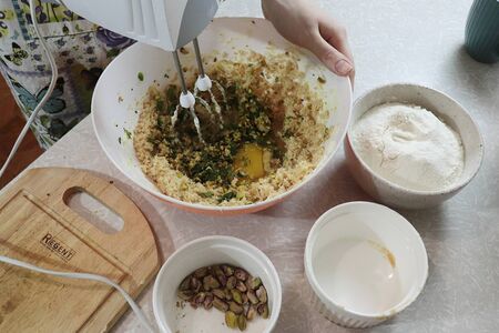 The process of preparing a dish of dough, lemons and pistachiosの写真素材