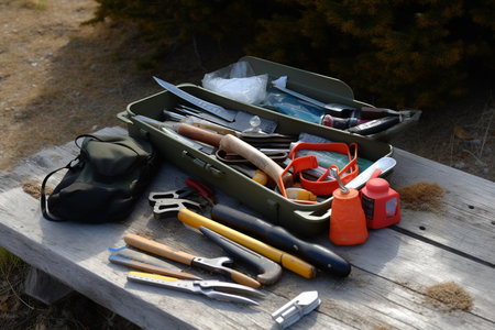 Set of tools for camping and hiking on a wooden bench in the forestの素材