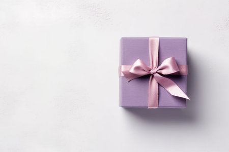 Gift box with pink bow on white background. Top view with copy spaceの素材