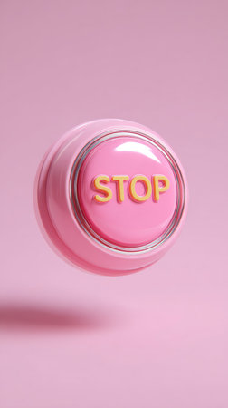 A close-up shot of a pink stop button with the word STOP in yellow letters.の素材