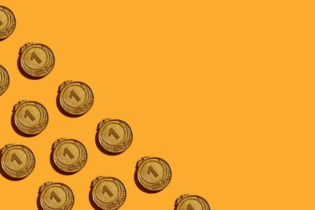 Background of gold medals with a hard shadow.