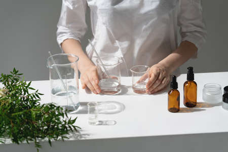 The scientist, dermatologist testing the organic natural cosmetic product in the laboratory. Vials,...
