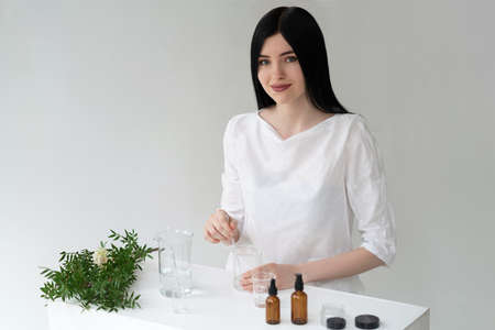 The scientist, dermatologist testing the organic natural cosmetic product in the laboratory. Vials, glass laboratory flasks. Beauty cosmetic research and development concept.の写真素材