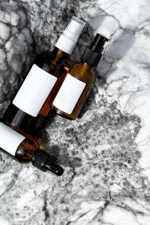 Cosmetic bottles on a marble background. Top view with space for text.の写真素材