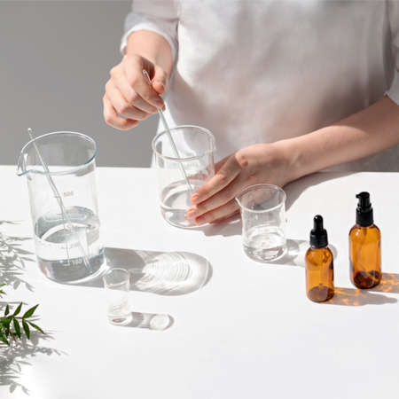 The scientist, dermatologist testing the organic natural cosmetic product in the laboratory. Vials,...