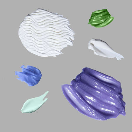 Samples of cream on a uniform background.