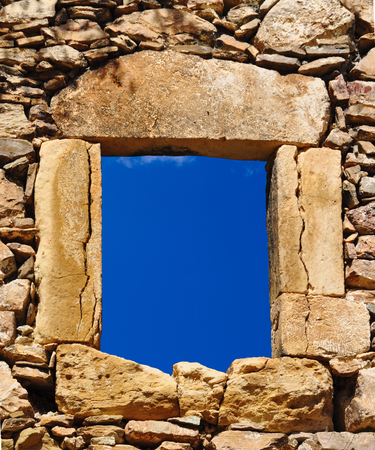 Traditional stone window and blue skyの写真素材