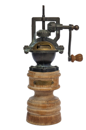 Vintage wooden pepper grinder isolated over whiteの写真素材