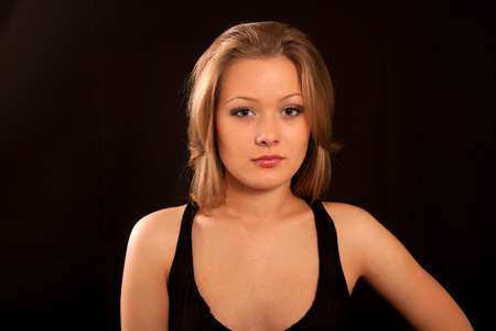 Portrait of the charming girl on a black backgroundの写真素材