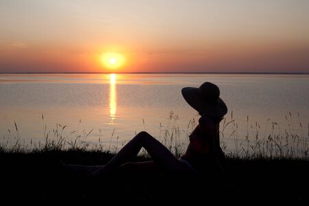 beautiful girl in beams of an evening declineの写真素材