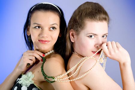 Two young beautiful girls in elegant dressesの写真素材