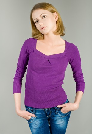 The beautiful young girl in jeans and a blouseの写真素材