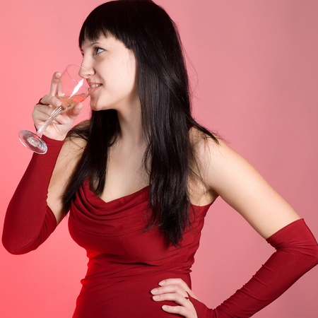 The girl in a red dress with a champagne glassの写真素材