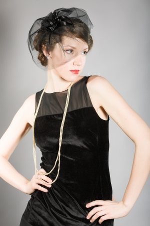 beautiful woman in a black dress retroの写真素材