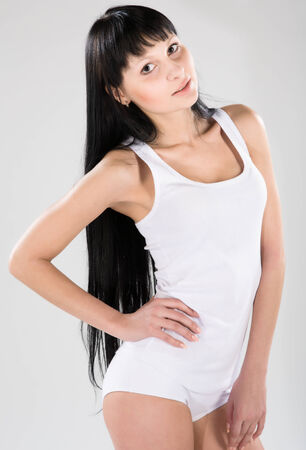 Young attractive brunette in white shirtの写真素材