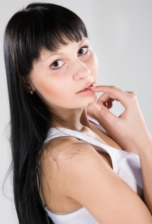 Young attractive brunette in white shirtの写真素材